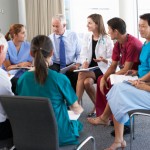 Medical Staff Seated In Circle At Case Meeting